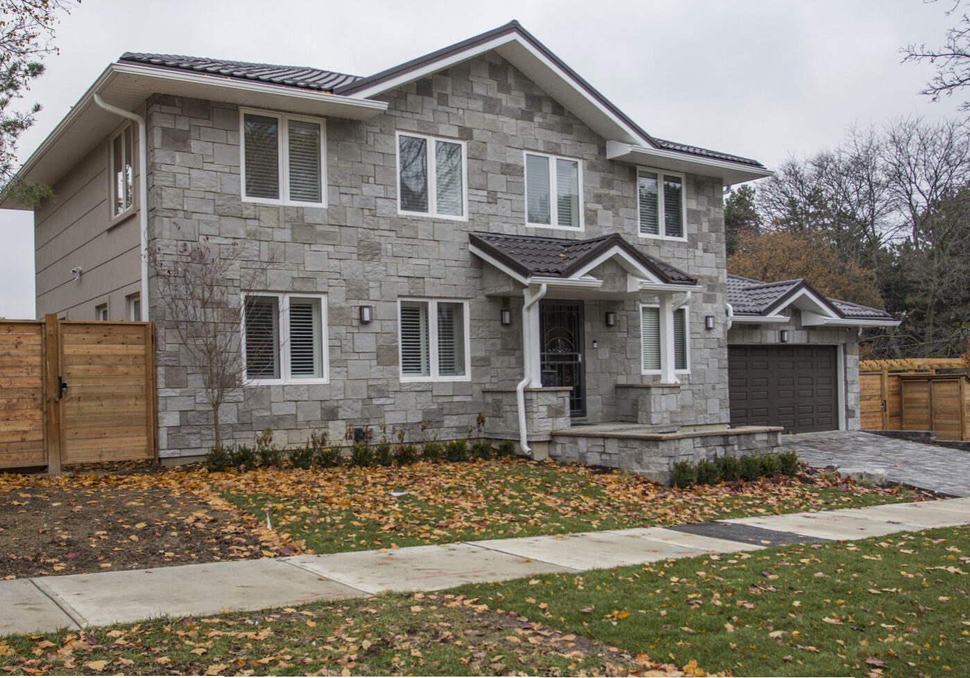 Stone & stucco facade, steel roof, energy efficient windows.  North York house addition & renovation.